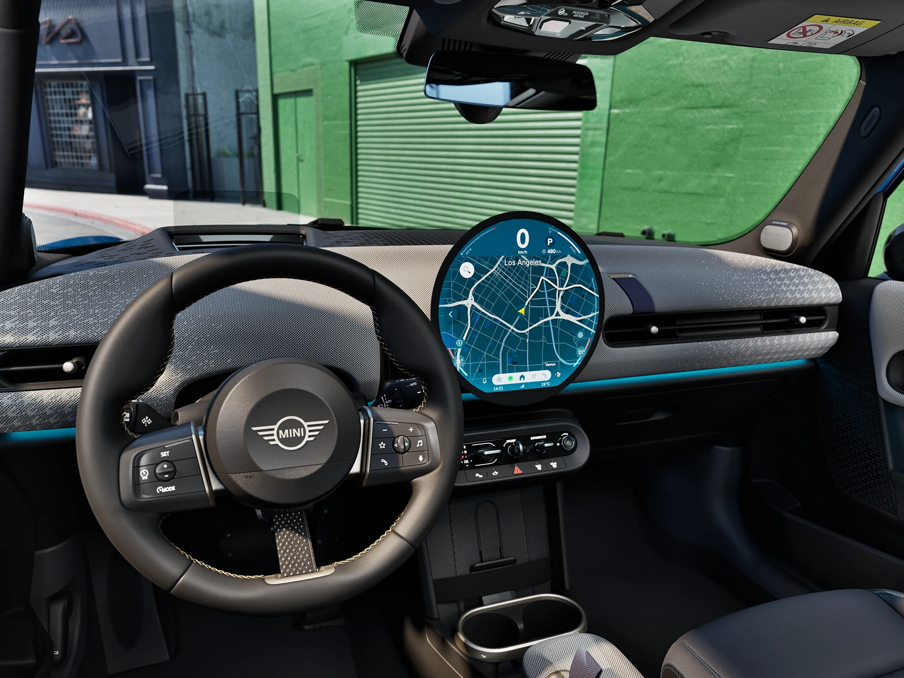 Interior view of the MINI Cooper 5-Door with focus on the steering wheel, the dashboard and the interaction unit.